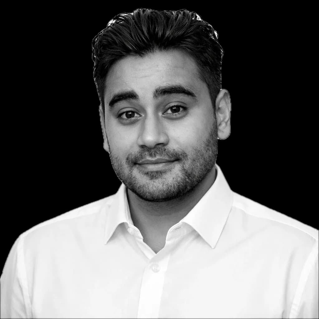 Mocha Adam smiling, wearing a white shirt